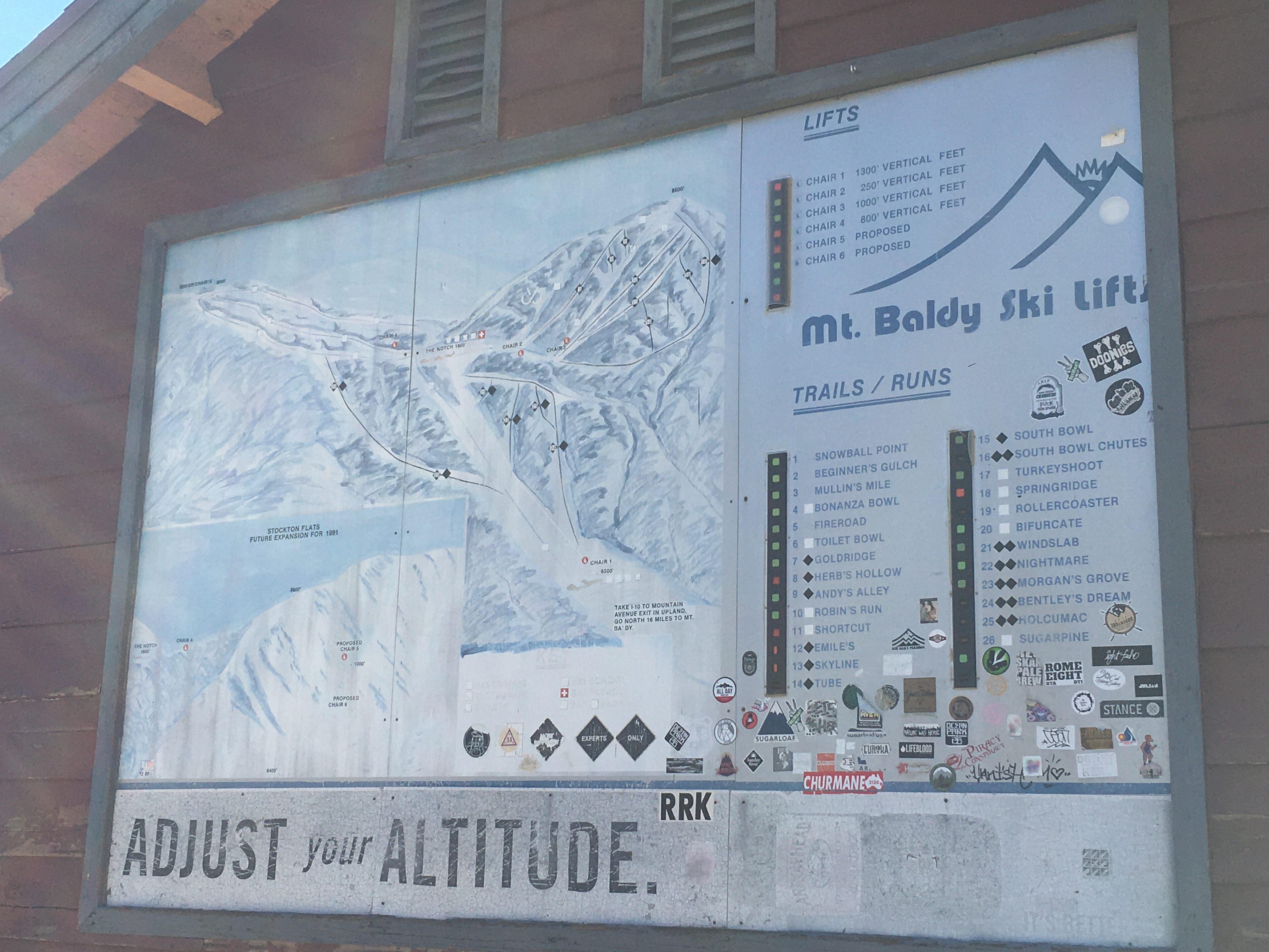 mt. baldy ski lift map at top of the notch, labeled lifts and ski runs littered with many cool-guy stickers